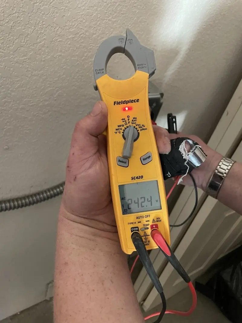 Voltage testing with clamp meter during Electrical Installation Services in Edgewater